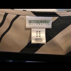 Motherhood Maternity cream and black dress.